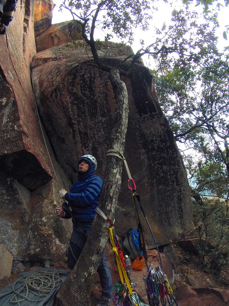 Getting cold in the shade with the rain threatening to pour on us and Naldo climbing Scarface